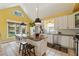 Bright eat-in kitchen featuring a vaulted ceiling, granite island with seating, stainless appliances, and ample natural light at 518 Hill St Se, Atlanta, GA 30312