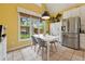 This kitchen boasts a stainless steel refrigerator and a dining area with windows at 518 Hill St Se, Atlanta, GA 30312