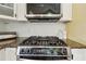 Stainless steel gas stove and oven with granite countertops and white cabinets at 518 Hill St Se, Atlanta, GA 30312