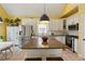 Eat-in kitchen with stainless steel appliances, granite island with seating, and wine storage. Vaulted ceilings at 518 Hill St Se, Atlanta, GA 30312