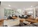 Bright living room with neutral colors, hardwood floors, and multiple seating areas, offering a cozy and inviting space at 518 Hill St Se, Atlanta, GA 30312
