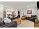 Open-concept living room with adjacent bar, dark wood floors, and leather furniture at 518 Hill St Se, Atlanta, GA 30312
