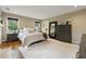 Bright main bedroom featuring hardwood floors, a white rug, with a large dresser and mirrors at 518 Hill St Se, Atlanta, GA 30312