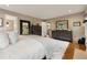 Main bedroom featuring hardwood floors, a fireplace, white rug, and a large dresser at 518 Hill St Se, Atlanta, GA 30312