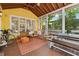 Cozy screened porch with wood benches, orange rug, ceiling fan and a view of the backyard at 518 Hill St Se, Atlanta, GA 30312