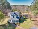 Stunning aerial view of a two-story home, lush greenery, and a serene pond backdrop at 1768 Hood Rd, Dacula, GA 30019
