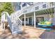 Charming outdoor space featuring a patio with a swing, stairs to the backyard, and a well-manicured lawn at 1768 Hood Rd, Dacula, GA 30019