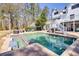 Beautiful backyard with a large swimming pool, hot tub, and spacious brick patio at 1768 Hood Rd, Dacula, GA 30019