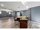 Open basement design features recessed lighting, stylish flooring, and a granite countertop bar at 1768 Hood Rd, Dacula, GA 30019