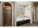 Bathroom featuring a soaking tub, shower, and decorative tile at 1768 Hood Rd, Dacula, GA 30019