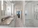 Bathroom featuring a long countertop with dual sinks and a glass enclosed shower at 1768 Hood Rd, Dacula, GA 30019