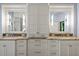 Bathroom with dual vanities, granite countertops, and white cabinetry offering ample storage space at 1768 Hood Rd, Dacula, GA 30019