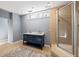 Modern bathroom featuring double vanity with marble countertop and a glass-enclosed shower with decorative tile at 1768 Hood Rd, Dacula, GA 30019