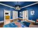 Stylish bedroom with hardwood floors, a Murphy bed, and colorful rug at 1768 Hood Rd, Dacula, GA 30019