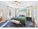 Serene bedroom with a plush bed, contemporary decor, and ample natural light, creating a tranquil retreat at 1768 Hood Rd, Dacula, GA 30019