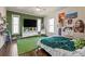 Unique bedroom with natural light, hardwood floors, and decorative green wall at 1768 Hood Rd, Dacula, GA 30019