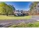 Beautiful home situated on a large lot with mature trees and a long driveway at 1768 Hood Rd, Dacula, GA 30019