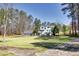 Beautiful home with a well-maintained lawn, towering trees, and a three-car garage at 1768 Hood Rd, Dacula, GA 30019