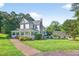 Charming two-story home featuring a welcoming wrap-around porch and meticulously landscaped front yard at 1768 Hood Rd, Dacula, GA 30019