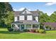 Charming two-story home with a welcoming front porch, brick walkway and mature landscaping at 1768 Hood Rd, Dacula, GA 30019