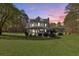 Inviting two-story home with a welcoming front porch and well-manicured lawn at sunset at 1768 Hood Rd, Dacula, GA 30019