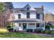 Attractive home with a welcoming front porch, a lush yard, and beautiful landscaping at 1768 Hood Rd, Dacula, GA 30019