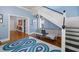 Light-filled foyer featuring hardwood floors, staircase, and stylish decor with beautiful blue walls at 1768 Hood Rd, Dacula, GA 30019