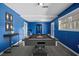Bright game room featuring blue walls, a gray pool table, and natural light from windows at 1768 Hood Rd, Dacula, GA 30019