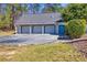 Three-car garage and extra blue door, offering plenty of space for vehicles and storage at 1768 Hood Rd, Dacula, GA 30019
