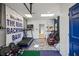 Finished basement gym with a blue accent wall, colorful rug, and exercise equipment at 1768 Hood Rd, Dacula, GA 30019
