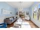 Cozy living room with hardwood floors, wainscoting, and views into other rooms at 1768 Hood Rd, Dacula, GA 30019