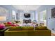 Bright living room features hardwood floors, colorful couches, and a modern fireplace at 1768 Hood Rd, Dacula, GA 30019