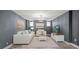 Cozy living room with soft white furniture, a decorative chandelier, and serene art at 1768 Hood Rd, Dacula, GA 30019