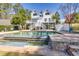 Gorgeous in-ground pool with an attached waterfall feature, surrounded by patio furniture at 1768 Hood Rd, Dacula, GA 30019