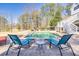 Inviting swimming pool surrounded by brick patio, lounge chairs, and lush landscaping at 1768 Hood Rd, Dacula, GA 30019