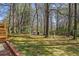 Expansive backyard featuring mature trees, storage shed, and play set at 1863 Bruce Ne Rd, Atlanta, GA 30329