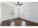 Bedroom featuring hardwood floors, a ceiling fan, and natural light from two windows at 1863 Bruce Ne Rd, Atlanta, GA 30329
