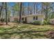 Well-maintained ranch with white painted brick, manicured lawn, and mature trees at 1863 Bruce Ne Rd, Atlanta, GA 30329