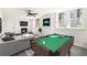 Recreation room with a pool table, modern fireplace, and comfortable seating area at 1863 Bruce Ne Rd, Atlanta, GA 30329