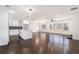 Open-concept kitchen and living area featuring hardwood floors, white cabinets, and fireplace at 1863 Bruce Ne Rd, Atlanta, GA 30329