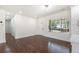 Bright living room with hardwood floors, large window, and white trim throughout at 1863 Bruce Ne Rd, Atlanta, GA 30329