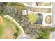 Aerial view of home, outbuilding, and green surrounding with baseball field in the distance at 2285 Bascomb Carmel Rd, Woodstock, GA 30189