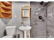 Updated bathroom with stylish tile shower, vanity, and decorative shelving at 2285 Bascomb Carmel Rd, Woodstock, GA 30189