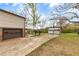 Long driveway leads to a home with multiple garages and a spacious backyard at 2285 Bascomb Carmel Rd, Woodstock, GA 30189