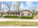 Charming single-story home with a covered front porch, complemented by mature landscaping and a spacious driveway at 2285 Bascomb Carmel Rd, Woodstock, GA 30189