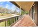 Cozy covered porch with wooden flooring and white railings at 2285 Bascomb Carmel Rd, Woodstock, GA 30189