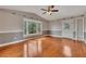 Well-lit living room featuring hardwood floors, neutral paint, a large window, and an exterior door at 2285 Bascomb Carmel Rd, Woodstock, GA 30189