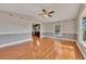 Open living room featuring hardwood floors, gray wainscoting, and a glimpse into the updated kitchen at 2285 Bascomb Carmel Rd, Woodstock, GA 30189
