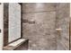 Luxurious shower with stone tile and mosaic accents, featuring built in bench at 2285 Bascomb Carmel Rd, Woodstock, GA 30189