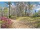 Expansive backyard with wooded area and split rail fence and stream at 3272 Creek E Trce, Powder Springs, GA 30127